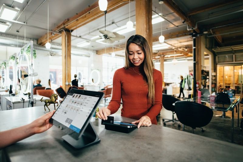 A shop assistant taking a card payment at a retail counter