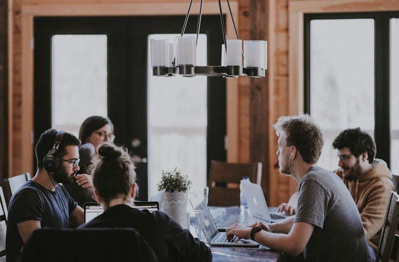 A team working together around a long table in a bright meeting room